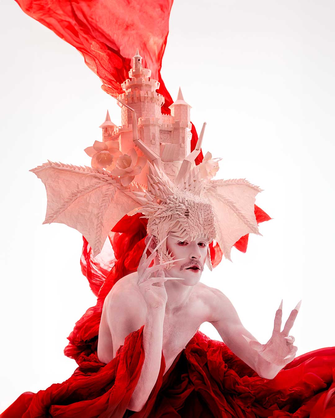 Bold, high-fashion image of a drag queen performer in vibrant lighting London Icon